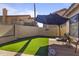 Backyard featuring lush artificial grass and a cozy patio area at 10733 W Clover Way, Avondale, AZ 85392