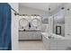 Elegant bathroom with dual sinks, stylish mirrors, and a modern bathtub with white subway tile at 10733 W Clover Way, Avondale, AZ 85392