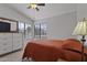 Bright bedroom with a ceiling fan and large windows that provide natural light at 10733 W Clover Way, Avondale, AZ 85392