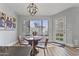Inviting dining area with a modern chandelier, kitchen view, and abundant natural light at 10733 W Clover Way, Avondale, AZ 85392