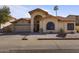 Charming single-story home featuring a red tile roof, arched entryway, and well-maintained landscaping at 10733 W Clover Way, Avondale, AZ 85392