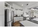 Stylish kitchen featuring white cabinetry, stainless steel appliances, and an open layout at 10733 W Clover Way, Avondale, AZ 85392