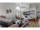 Bright living room featuring wood floors, a ceiling fan, and a fireplace with a shiplap accent wall at 10733 W Clover Way, Avondale, AZ 85392