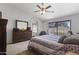 Comfortable main bedroom with a dresser, ceiling fan, and sliding glass doors to the backyard at 10733 W Clover Way, Avondale, AZ 85392