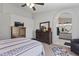 Spacious main bedroom with dresser, ceiling fan, and ensuite bathroom with dual sinks and tub at 10733 W Clover Way, Avondale, AZ 85392