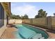 Backyard pool with blue water and stone surround with a private fence, ideal for outdoor entertaining at 10733 W Clover Way, Avondale, AZ 85392
