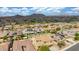 This aerial view shows a desert community with tile roofs, desert landscaping, and mountain views at 10741 W Paso Trl, Peoria, AZ 85383