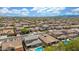 A wide aerial shot displays a sprawling residential community, desert landscaping, and clear skies at 10741 W Paso Trl, Peoria, AZ 85383