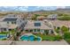 Aerial view of backyard with pool, putting green, covered patio and views to the community at 10741 W Paso Trl, Peoria, AZ 85383