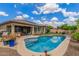 Beautiful backyard with a refreshing pool, covered patio, and putting green, ideal for outdoor living at 10741 W Paso Trl, Peoria, AZ 85383