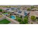 This backyard features a pool, putting green, privacy fence, and mature landscaping at 10741 W Paso Trl, Peoria, AZ 85383
