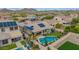 Wonderful backyard featuring a sparkling pool, putting green, covered patio, and solar panels on the roof at 10741 W Paso Trl, Peoria, AZ 85383