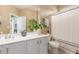 Bright bathroom featuring a white vanity, modern fixtures, and decorative plants at 10741 W Paso Trl, Peoria, AZ 85383