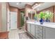 Bathroom featuring a double vanity, white cabinets, tile floors and light-colored walls at 10741 W Paso Trl, Peoria, AZ 85383