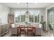 The dining room features a wooden table, decorative pendant lighting and plantation shutters at 10741 W Paso Trl, Peoria, AZ 85383