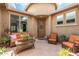 Inviting front porch with cozy seating area, perfect for relaxing and enjoying the neighborhood at 10741 W Paso Trl, Peoria, AZ 85383