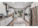 Open concept kitchen with stainless steel appliances, white cabinets, and an island at 10741 W Paso Trl, Peoria, AZ 85383