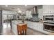 This kitchen has white cabinets, stainless steel appliances, and an island with wood floors at 10741 W Paso Trl, Peoria, AZ 85383