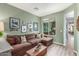 Inviting living room featuring a comfortable sectional sofa and bright light from the large window at 10741 W Paso Trl, Peoria, AZ 85383