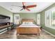 Large main bedroom featuring a ceiling fan, plantation shutters, and a bed frame at 10741 W Paso Trl, Peoria, AZ 85383