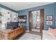 Home office featuring built-in shelving, a wooden desk, and an adjoining room at 10741 W Paso Trl, Peoria, AZ 85383