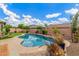 Refreshing backyard pool with a clean patio, lush greenery, and clear blue skies above at 10741 W Paso Trl, Peoria, AZ 85383
