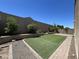 Secluded backyard with artificial turf and low-maintenance landscaping for easy upkeep at 10743 W Bronco Trl, Peoria, AZ 85383