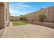 Desert backyard featuring a plush artificial lawn, and desert landscaping at 10743 W Bronco Trl, Peoria, AZ 85383
