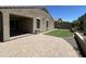Beautiful backyard featuring a paved patio, low-maintenance turf, and neutral color palette at 10743 W Bronco Trl, Peoria, AZ 85383