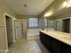 Bright bathroom features a double sink vanity, separate tub, and glass enclosed shower at 10743 W Bronco Trl, Peoria, AZ 85383