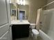 This bathroom features a shower/tub combination and dark vanity with a white sink at 10743 W Bronco Trl, Peoria, AZ 85383