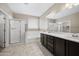Bathroom with double sink vanity, bathtub and separate walk-in shower at 10743 W Bronco Trl, Peoria, AZ 85383