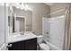 Bright bathroom featuring a tub with shower, large mirror, and dark wood vanity at 10743 W Bronco Trl, Peoria, AZ 85383