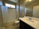 This bathroom features a shower/tub combination and dark vanity with a white sink at 10743 W Bronco Trl, Peoria, AZ 85383