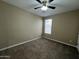 This bedroom has neutral colored walls and carpet with a window at 10743 W Bronco Trl, Peoria, AZ 85383