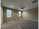 Spacious bedroom with neutral walls, carpet, and windows offering lots of natural light at 10743 W Bronco Trl, Peoria, AZ 85383