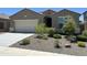 Charming single-story home with a well-maintained front yard and a two-car garage at 10743 W Bronco Trl, Peoria, AZ 85383