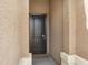 A covered front entry showcasing a secure metal screened front door with a welcome mat at the threshold at 10743 W Bronco Trl, Peoria, AZ 85383