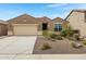 Charming single-story home featuring a desert landscaped front yard and an attached two car garage at 10743 W Bronco Trl, Peoria, AZ 85383