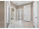Hallway featuring tiled floors with doorway views to the bathroom and a carpeted bedroom at 10743 W Bronco Trl, Peoria, AZ 85383