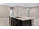 Close up of kitchen island featuring dark cabinets, stainless steel dishwasher, and granite countertop at 10743 W Bronco Trl, Peoria, AZ 85383