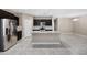 Spacious kitchen features dark cabinetry, stainless steel appliances, and a large granite island at 10743 W Bronco Trl, Peoria, AZ 85383