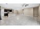 Open floor plan showcasing the kitchen with tiled floors flowing into an expansive living area at 10743 W Bronco Trl, Peoria, AZ 85383