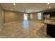 Open-concept living room with tile flooring, ceiling fan, and sliding glass doors to the patio at 10743 W Bronco Trl, Peoria, AZ 85383