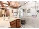 Updated bathroom with glass shower and marble-tiled walls at 111 S Greenfield Rd # 119, Mesa, AZ 85206