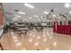 Expansive event space with tables, chairs and wooden dance floor, ideal for community gatherings at 111 S Greenfield Rd # 119, Mesa, AZ 85206