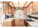 Kitchen featuring updated appliances, wooden cabinets and laminate countertops at 111 S Greenfield Rd # 119, Mesa, AZ 85206