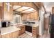 Kitchen featuring updated appliances, wooden cabinets and laminate countertops at 111 S Greenfield Rd # 119, Mesa, AZ 85206