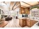 Open floor plan kitchen with wood cabinets, stainless appliances, and breakfast bar at 111 S Greenfield Rd # 119, Mesa, AZ 85206