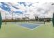 Outdoor pickleball courts offer a fun recreational amenity with well-maintained green and blue playing surfaces and shaded seating area at 111 S Greenfield Rd # 119, Mesa, AZ 85206